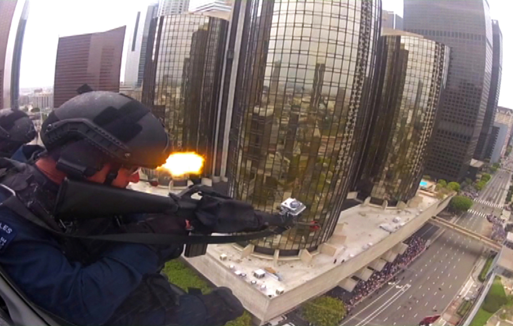 Police officers fire blank rounds from a helicopter in a drill simulating a terrorist attack in downtown Los Angeles. After a decade of sending military equipment to civilian police departments, Washington is reconsidering the idea in light of the violence in Ferguson, Mo.