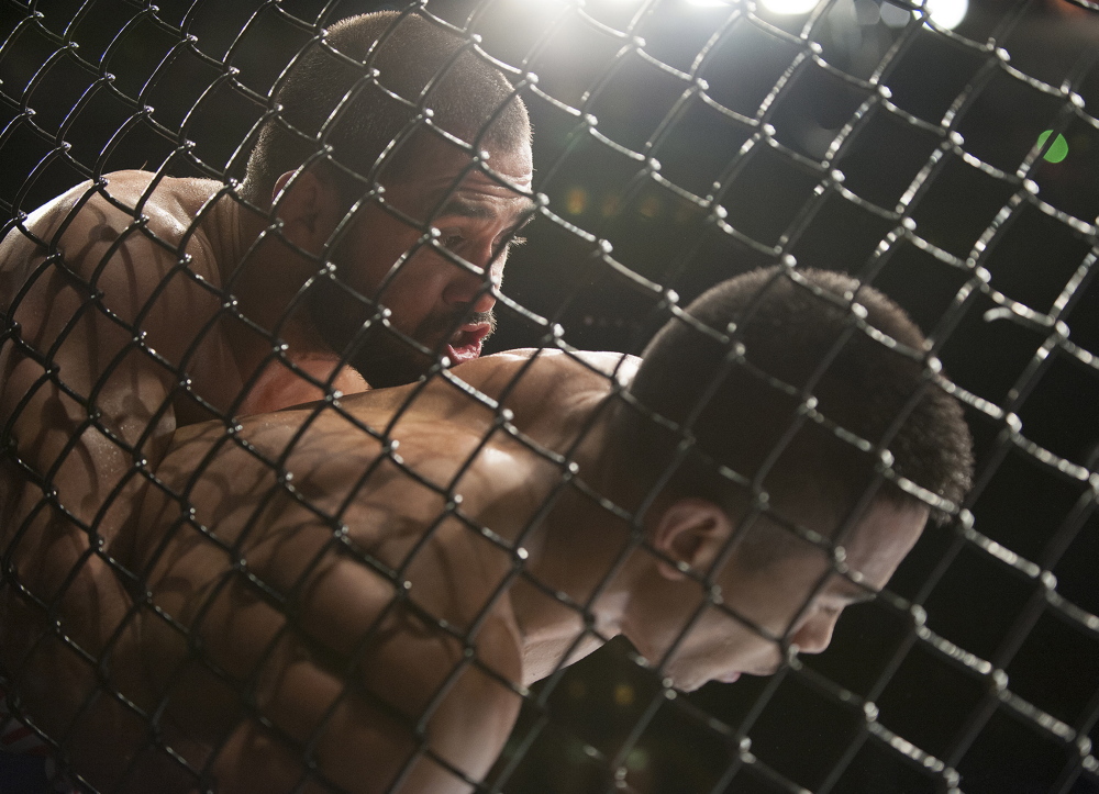 Nolan Ticman, red gloves, right, and Frankie Saenz, blue gloves, left, square off in a bantamweight bout at the Cross Insurance Center in Bangor on Saturday for  Ultimate Fighting Championship fight night.