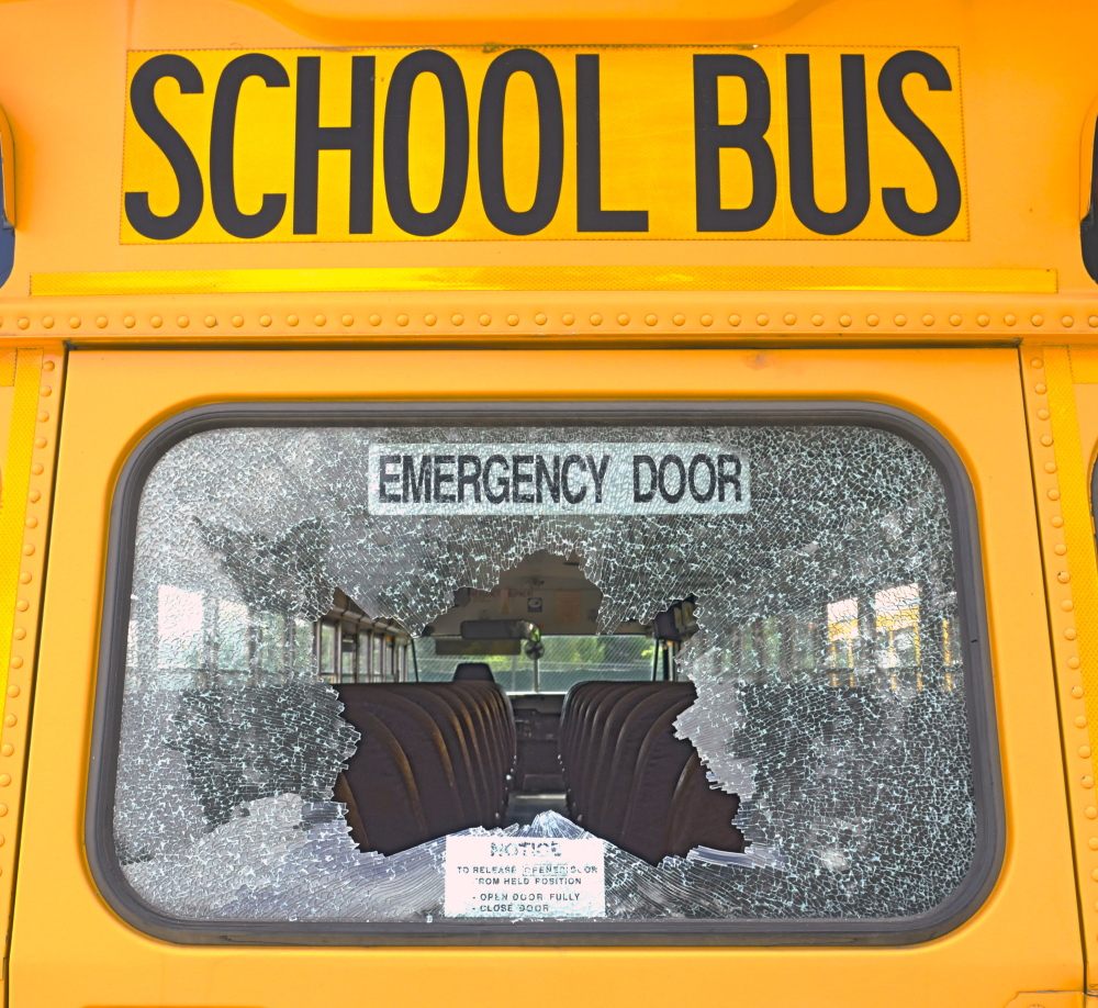 A broken rear window is seen Saturday on a school bus parked beside Monmouth Academy.