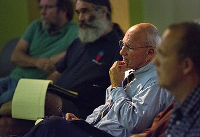 Mayor Michael Brennan listens as restaurant owner David Turin voices his support for an increase in the minimum wage, but not to rescind the current tip credit, at the Portland Public Library on Wednesday.