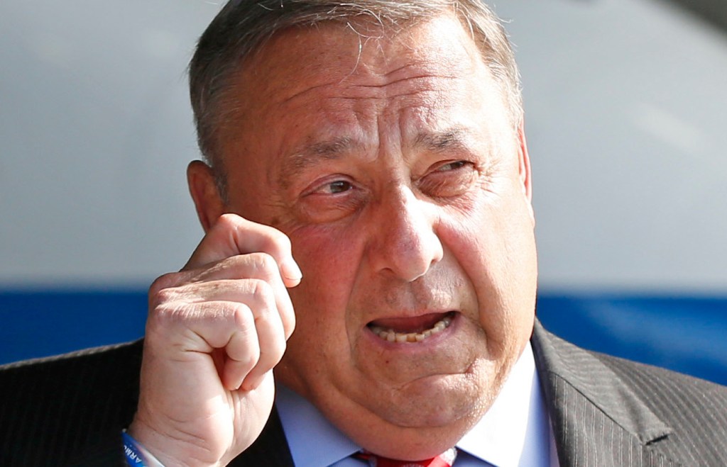 Maine Gov. Paul LePage, right, speaks to reporters while visiting C&L Aviation with New Jersey Gov. Chris Christie on Aug. 12 in Bangor.  