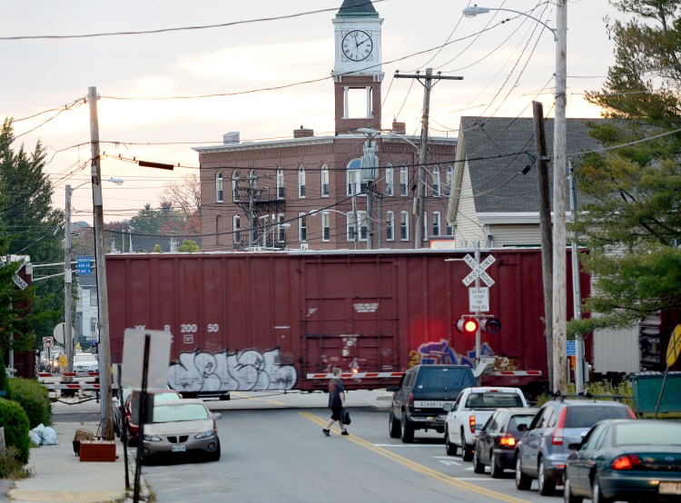 A freight train passes through Woodfords Corner in Portland. Federal money will help rehabilitate 380 miles of track throughout Maine and remove longstanding bottlenecks. 