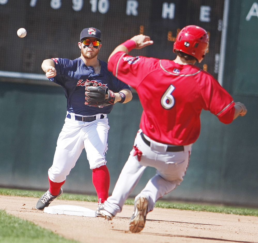 Sea Dogs’ second baseman Sean Coyle throws to first as Harrisburg’s Cole Leonida slides into second base Monday at Hadlock Field in Portland. Photographer)