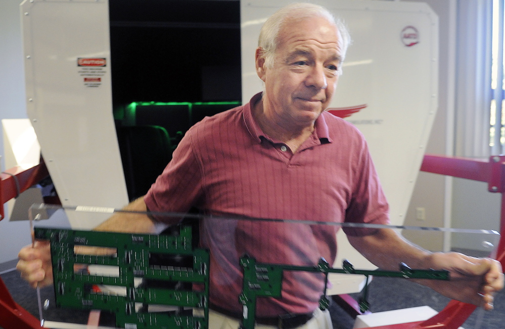 Jolda changes the instrument panel on the school’s new flight simulator.