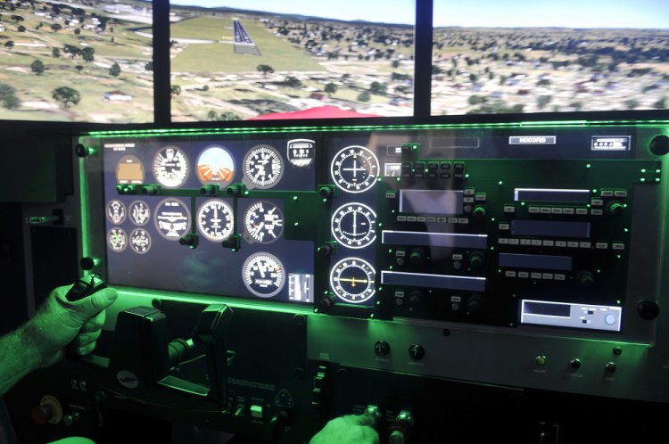 University of Maine at Augusta aviation program coordinator Greg Jolda pilots the school’s new flight simulator Thursday at the Augusta campus.