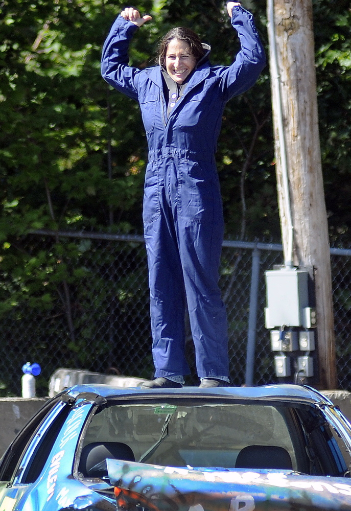 Lezley Sturtevant pumps her arms Sunday after winning a round at the demolition derby at the Litchfield Fair.