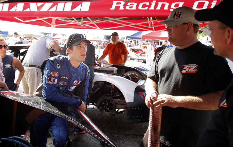 Race driver Austin Theriault, center, in blue, will drive a Maine-themed race car in a NASCAR race.