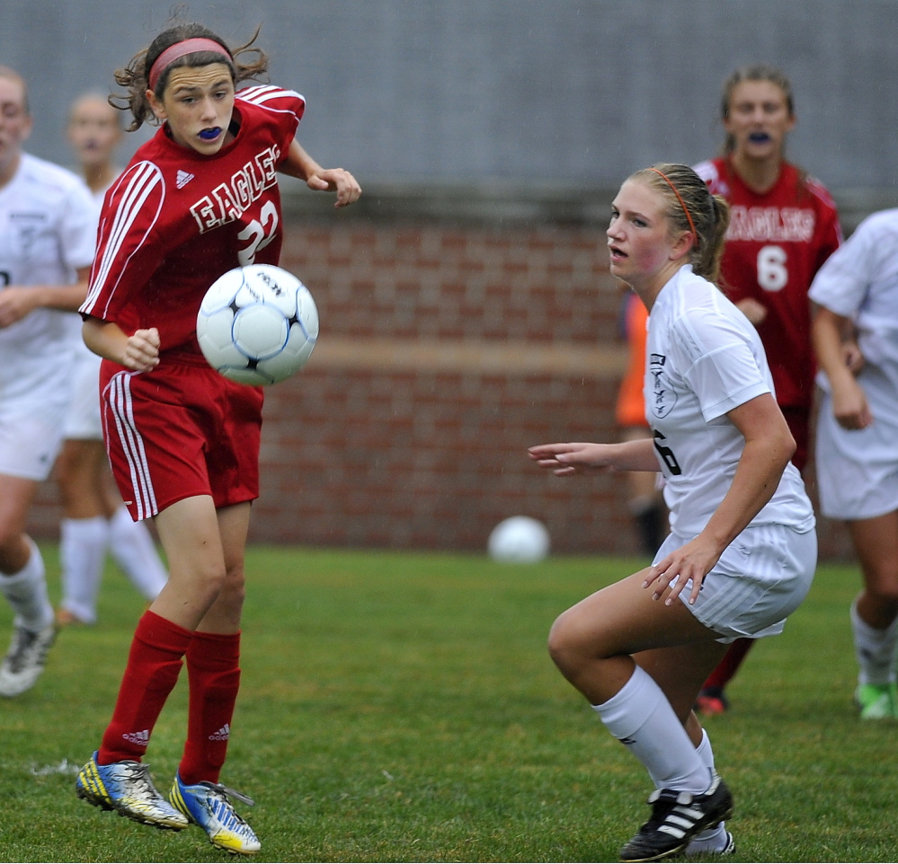 Mt. Ararat’s Nikki Bradstreet, left, heads the ball to a teammate past Molly Gramins of Brunswick during Thursday’s girls’ soccer game, won by Brunswick,  2-1.
