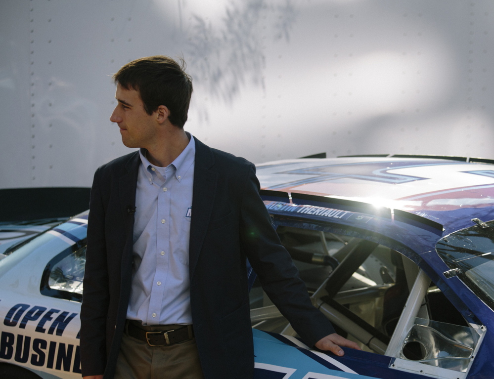 Austin Theriault, 20, poses in Portland’s Old Port with a car emblazoned with phrases touting Maine. Among young drivers seeking to be noticed, he separates himself from the pack with his Maine brand.