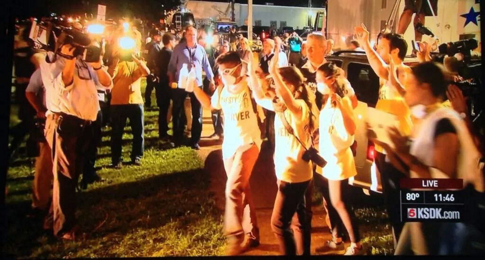 Colby College student Aquib Yacoob’s Amnesty International group is stopped at gunpoint by police in Ferguson, Mo., after all non-credentialed media was asked to leave the scene of the riots in the city last month.