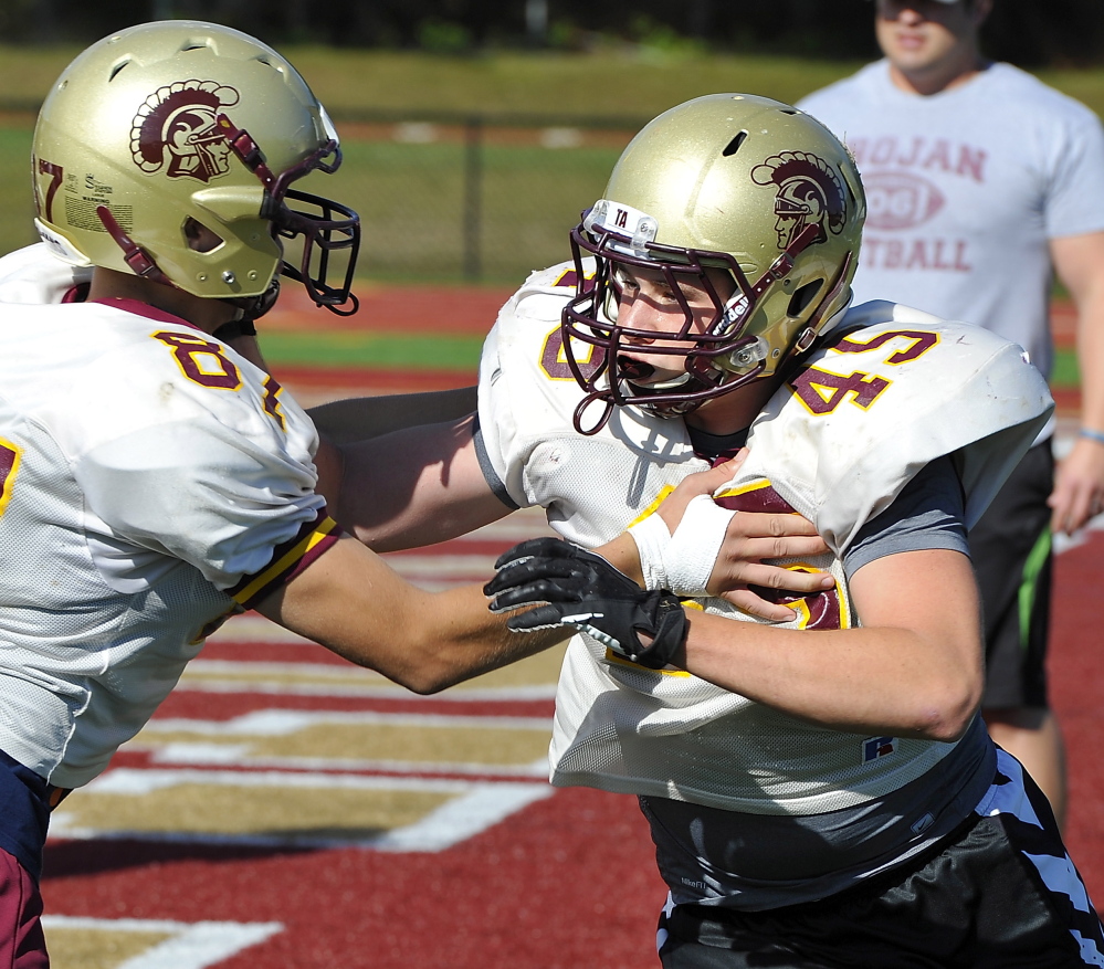Jimmy Remmes, right, has had many special moments for Thornton Academy described by his father, the P.A. announcer.