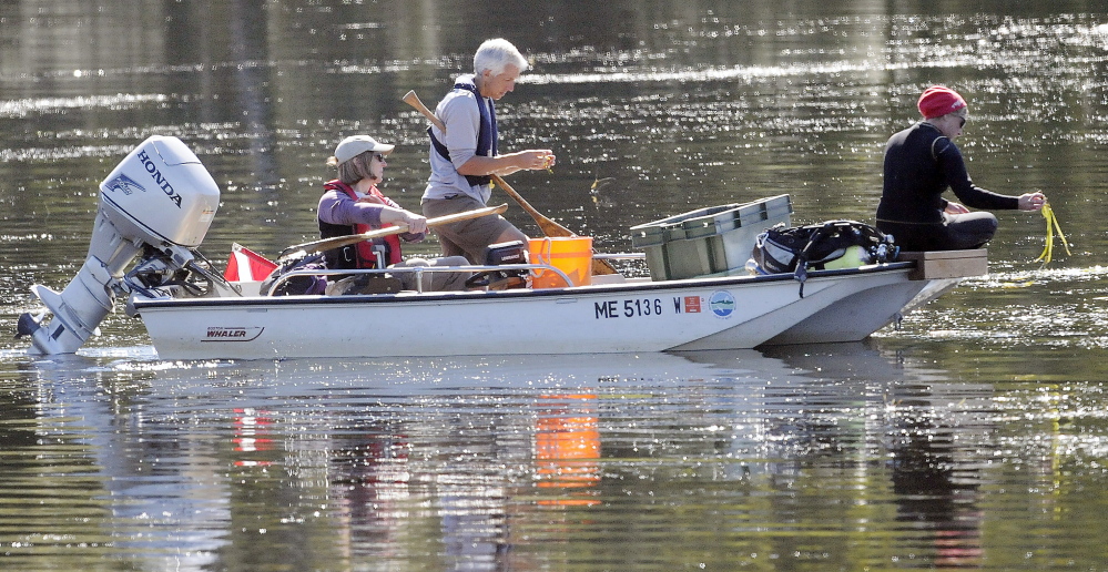 Crews from the Maine Department of Environmental Protection attempt to find invasive variable water milfoil in Annabessacook Lake in Winthrop on Wednesday.