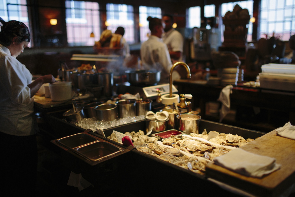 Fore Street line cooks prepare as dinner service starts at Fore Street Restaurant in Portland. Whitney Hayward/Staff Photographer