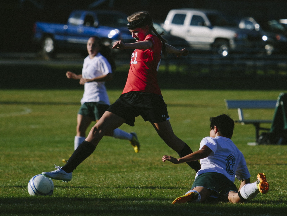 Sarah Barr of Scarborough dribbles past Kim Fisher of McAuley during their SMAA girls’ soccer game Friday at McAuley High. Scarborough came away with a 7-1 victory.