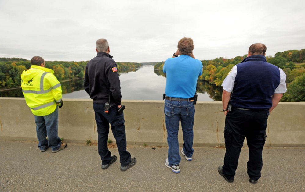 Waterville Fire Department Lt. Scott Holst, right center, spots a woman who was reported to have jumped from Carter Memorial Bridge into the Kennebec River just before 2 p.m. Tuesday. The bridge is on the Winslow/Waterville town line.
