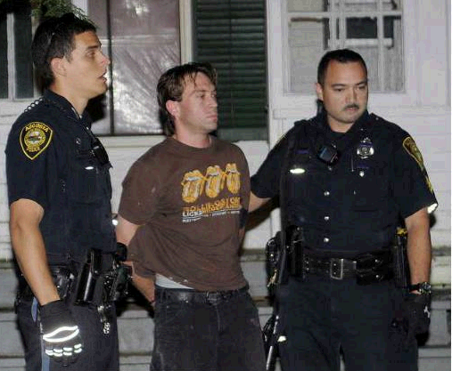 Augusta police escort Jason Boucher, 34, to an ambulance Monday outside a Cedar Street apartment building in which he barricaded himself for about an hour before surrendering to police. Boucher was charged in connection with a stabbing Saturday on Hospital Street.