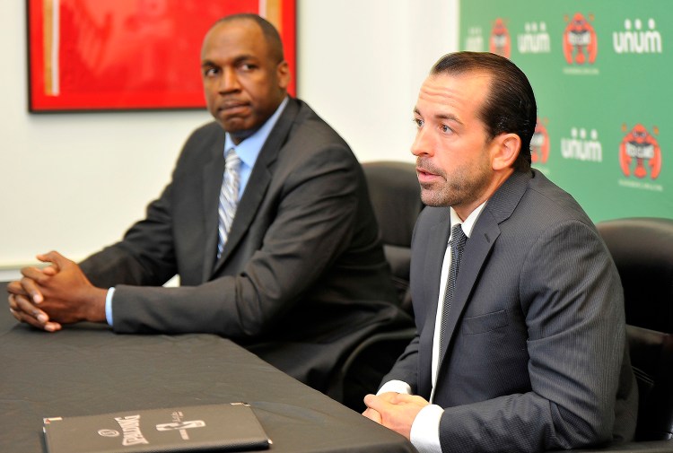 Maine Red Claws president Dujuan Eubanks, left, looks on as the new head coach, Scott Morrison, speaks to the media at a press conference at the team's Congress Street office. Gordon Chibroski / Staff Photographer