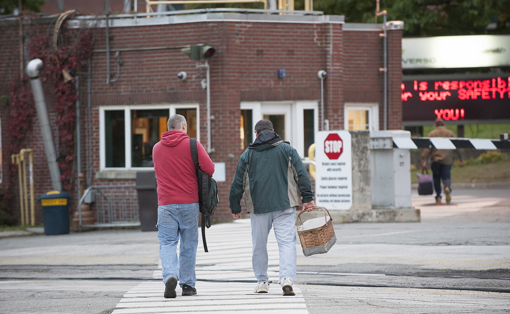 Workers enter the Verso mill in Bucksport on Thursday morning. Verso announced Wednesday that it will close the mill and lay off more than 500 workers in December. 
 Kevin Bennett Photo