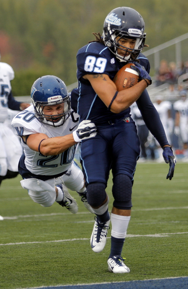 Maine's Arthur Williams drags Villanova's Joe Sarnese into the end zone with him after catching a 25-yard touchdown pass from quarterback Dan Collins  Saturday.