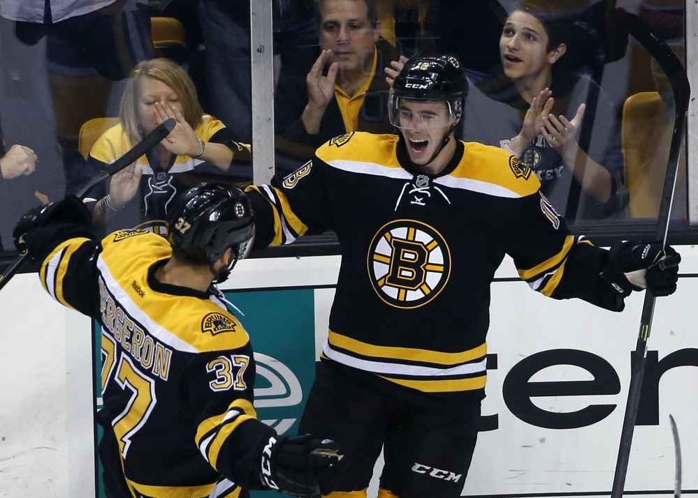 Boston Bruins right wing Reilly Smith, right, celebrates his goal with center Patrice Bergeron in the first period of Wednesday night’s 2-1 win over the Philadelphia Flyers in Boston.