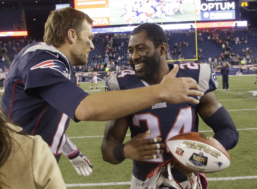 New England Patriots quarterback Tom Brady, left, hugs cornerback Darrelle Revis after last Sunday’s convincing victory over the Bengals. The Patriots have a showdown Sunday in Buffalo against the surprising Bills.