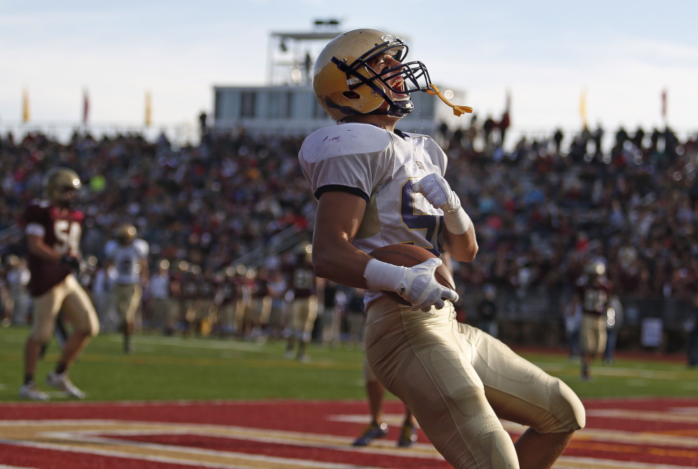 Zordan Holman of Cheverus lets out a yell after he scores toward the end of the first half of a football game at Thornton Academy Saturday. Gabe Souza/Staff Photographer