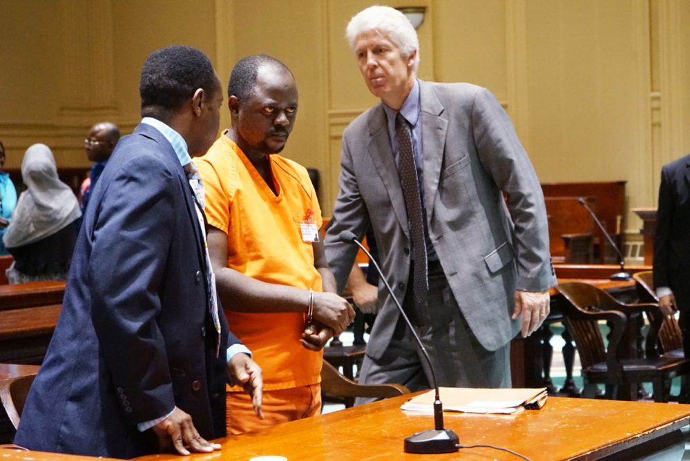 Evaristo Deus, 33, of Lewiston, center, appears in Androscoggin County Superior Court in Auburn with his attorney Justin Leary and an interpreter on Wednesday. Deus pleaded not guilty to a charge of murder.