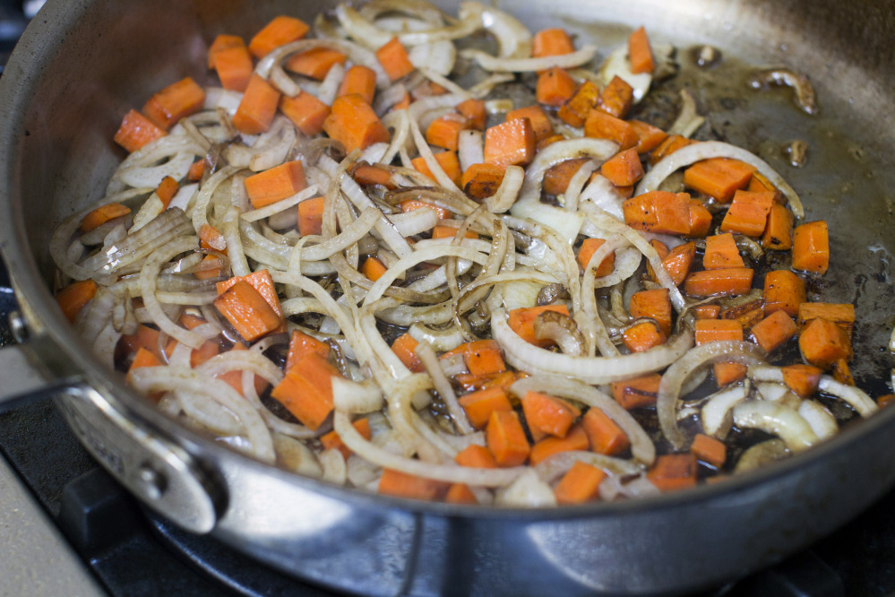 Sauteeing onions and carrots for red wine braised slow cooker short ribs.