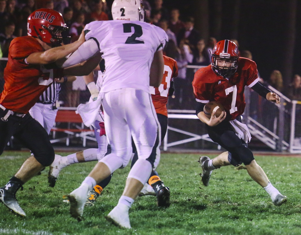 Wells quarterback Nate Booth looks for an opening Friday night against the Leavitt defensive line during Leavitt’s 26-19 comeback victory. Wells ends the regular season next weekend at Lake Region before the postseason begins. Whitney Hayward/Staff Photographer