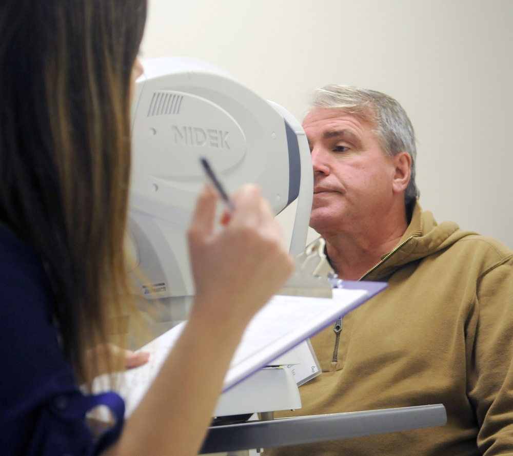 Charles Soule,of Lewiston receives an eye examination Saturday from optometry intern Emily Schwartz during the 17th Maine Homeless Veterans Stand Down at the Togus veterans’ hospital. Veterans from across Maine attended the event to receive medical attention, access to housing and employment and clothing at the federal hospital for veterans. Soule said he lives in transitional housing. 