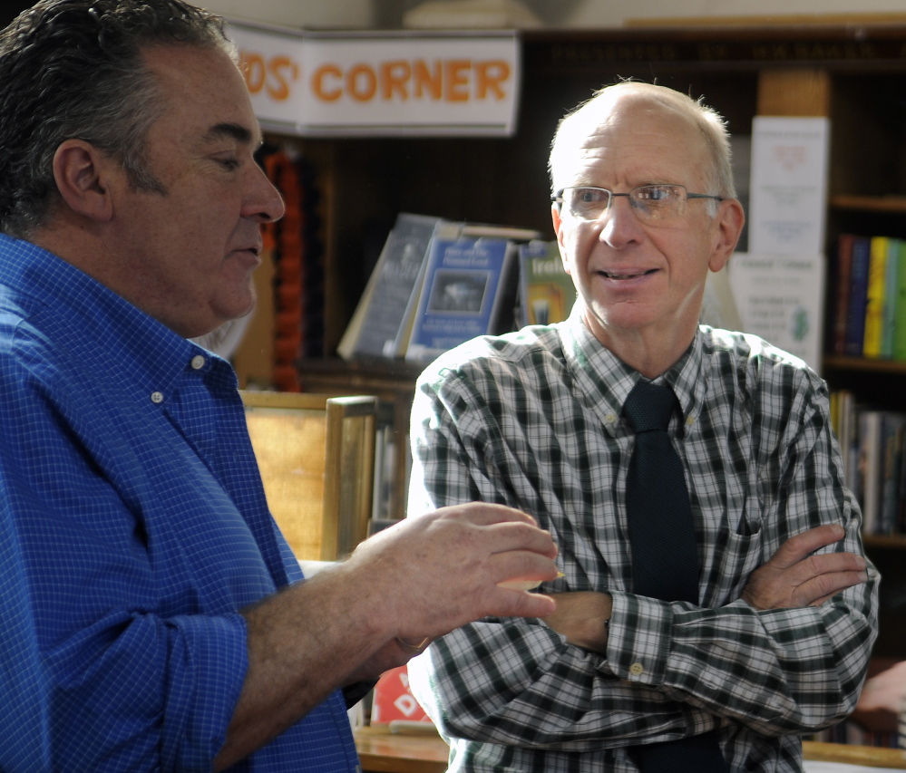 Hubbard Free Library Director Mark Blythe, right, confers with Alan Stearns Sunday during a celebration at the Hallowell institution.