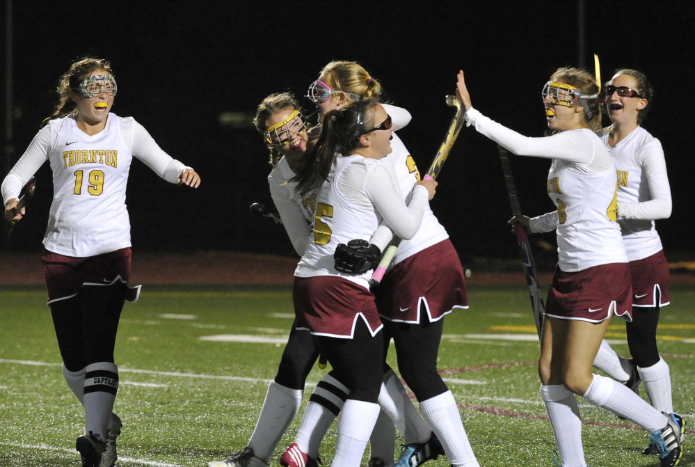 Grace Decker of Thornton Academy, center, is congratulated by teammates after scoring the first goal Wednesday night on the way to a 3-1 victory against Falmouth in the Western Class A field hockey quarterfinals at Saco.