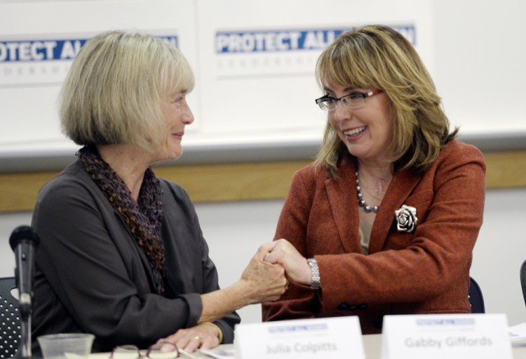 Julia Colpitts, executive director of the Maine Coalition to End Domestic Violence, left, and former Democratic U.S. Rep. Gabby Giffords of Arizona share a moment during Gifford’s visit to the University of Southern Maine as part of her Protect All Women Tour in October.