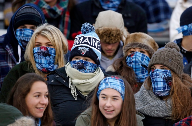 Maine fans cheer during a college football game between Maine and New Hampshire on Saturday in Orono. Organizers hoped to boost attendance by giving away bandannas in an attempt to set a Guinness world record.