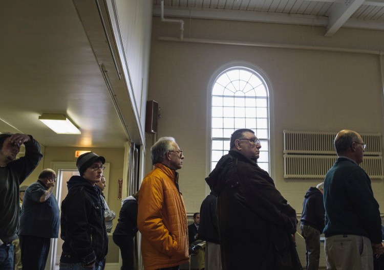 Voters wait to cast their ballots at Woodfords Congregational Church in Portland on Tuesday.