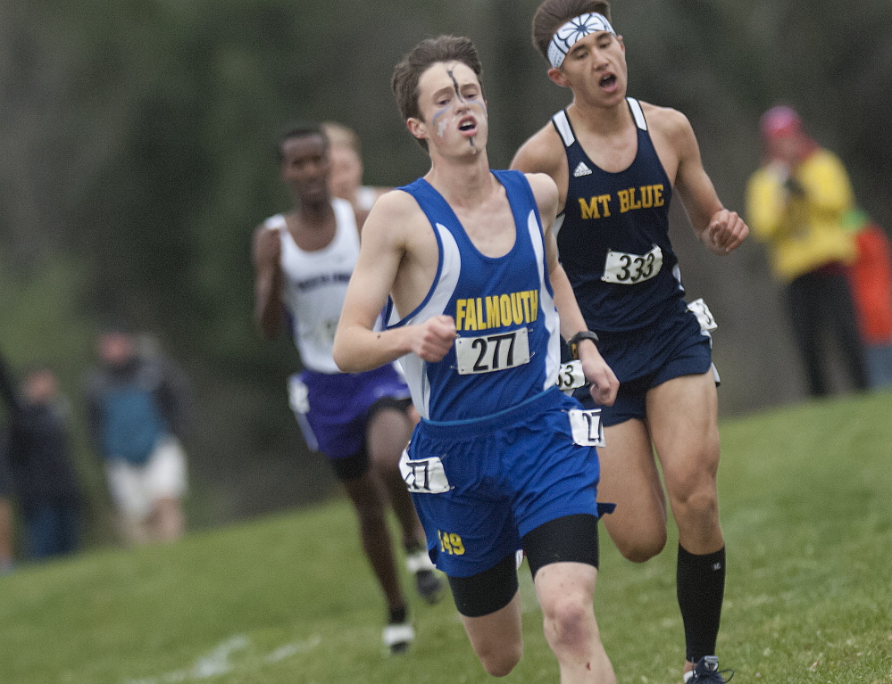 Falmouth’s Bryce Murdick edges ahead of Mt. Blue’s Aaron Willingham late in the Class A boys’ race at the cross country state championships Saturday in Belfast. 