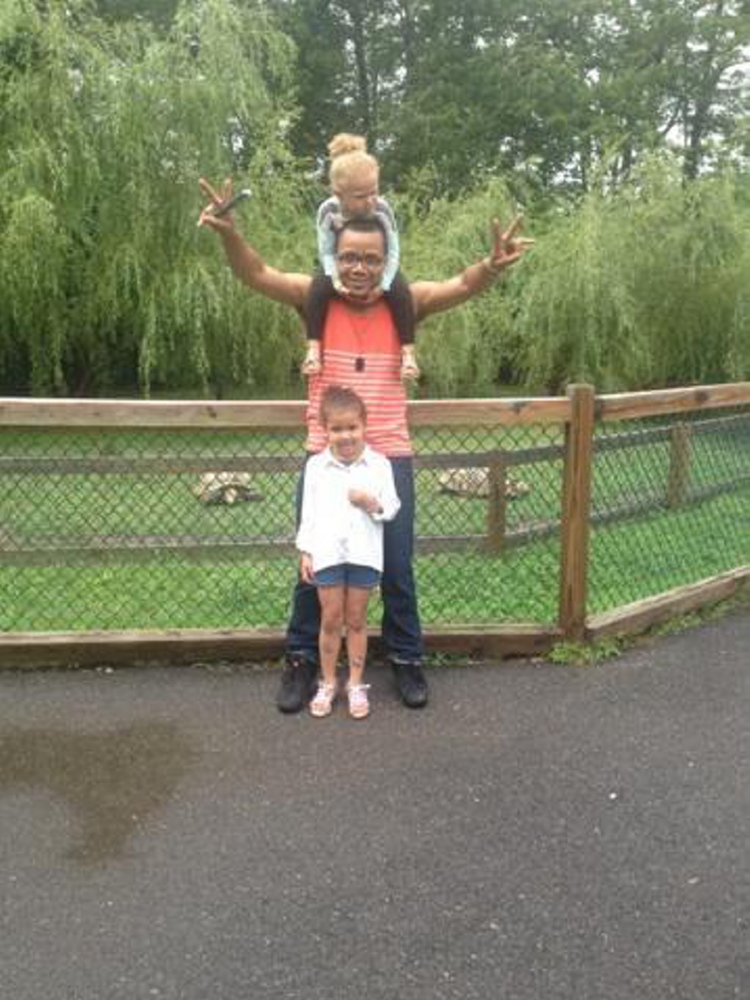 Steven Summers plays with his daughters, Audryn, 5, and, on his shoulders, Maliyah, 3, in August at York’s Wild Kingdom in York Beach.