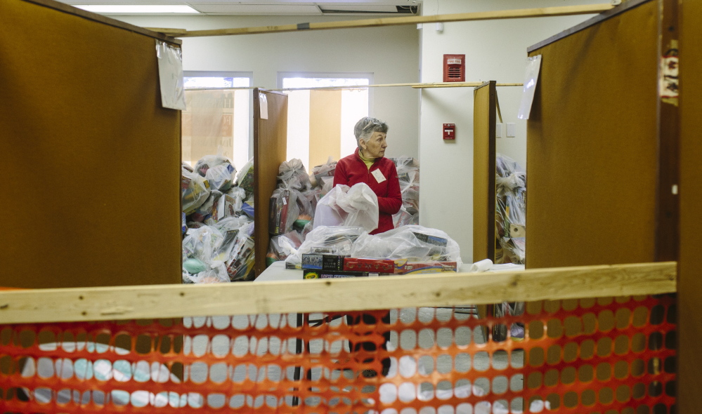 Judy Oliver packs toys for the Portland Press Herald Toy Fund in Freeport. The charity hopes to raise $250,000 this year.