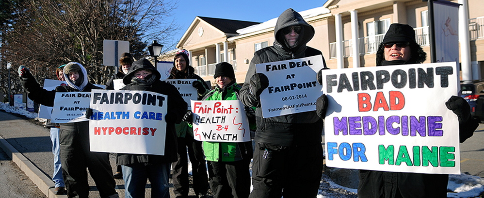 Bundled up against single-digit temperatures, strikers picket Tuesday outside a health care forum sponsored in part by FairPoint Communications. Union workers across New England went on strike against the telecommunications firm on Oct. 17 after the company imposed higher health insurance premiums and made other changes, union officials have said.