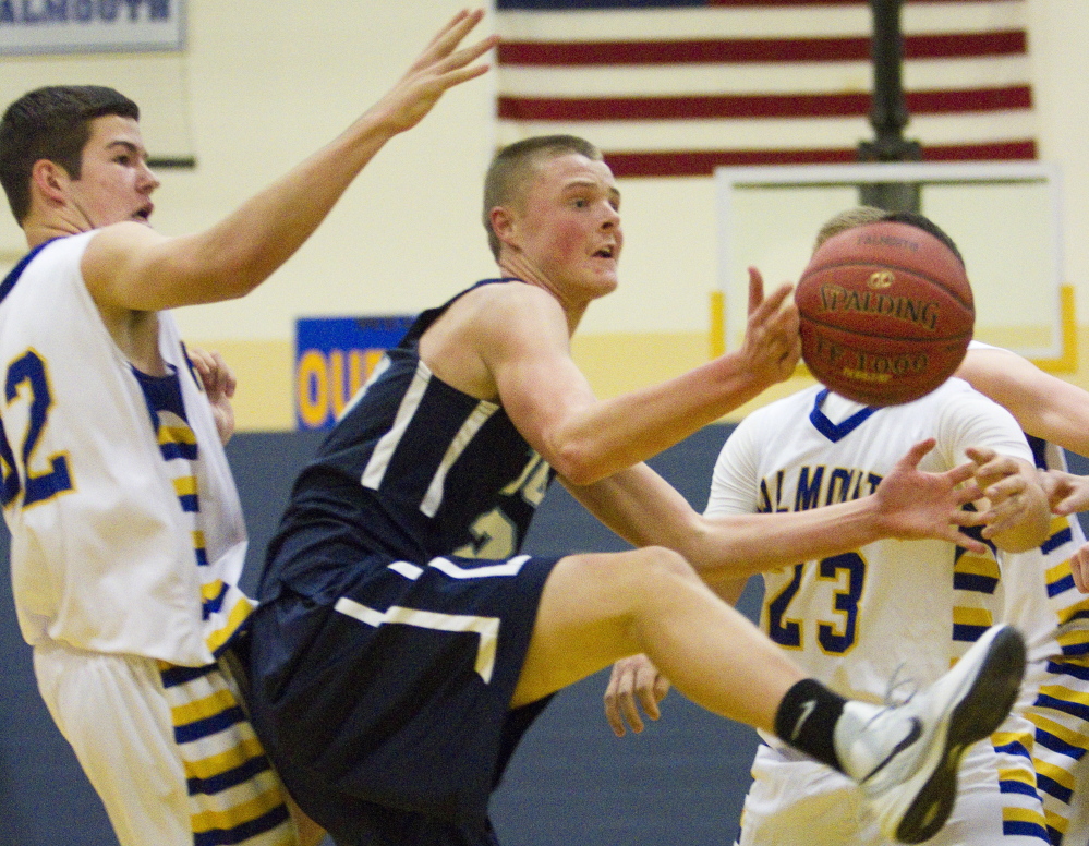 Trevor LaBonte of York attempts to control a rebound Friday night in front of Matt Wulbrecht of Falmouth during their Western Maine Conference opener. Falmouth pulled away to a 52-43 victory at home.