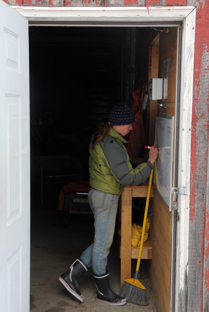 Katherine Creswell, farm manager in Kennebec Valley Community College’s sustainable agriculture program writes her to-do list on Friday. KVCC is the only community college in Maine with a sustainable agriculture program.