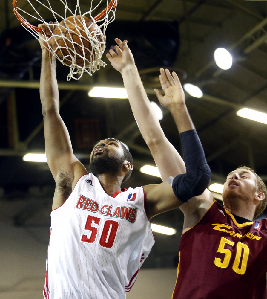 Ralph Sampson III dunks over Canton’s Alex Kirk in Maine’s 96-82 win Sunday at the Portland Expo. The Red Claws have the league’s best record at 9-2.