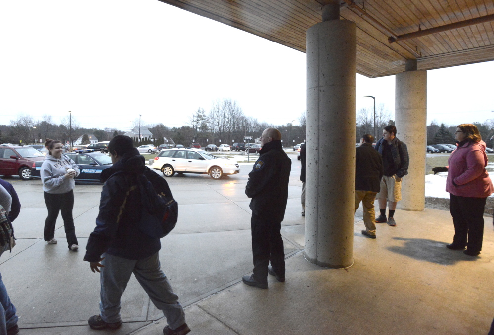 WINDHAM, ME - DECEMBER 18: Windham HS resource officer Jeff Smith (center) greets students as they and other students return to Windham schools after a threat canceled three days of classes. (Photo by John Patriquin/Staff Photographer)