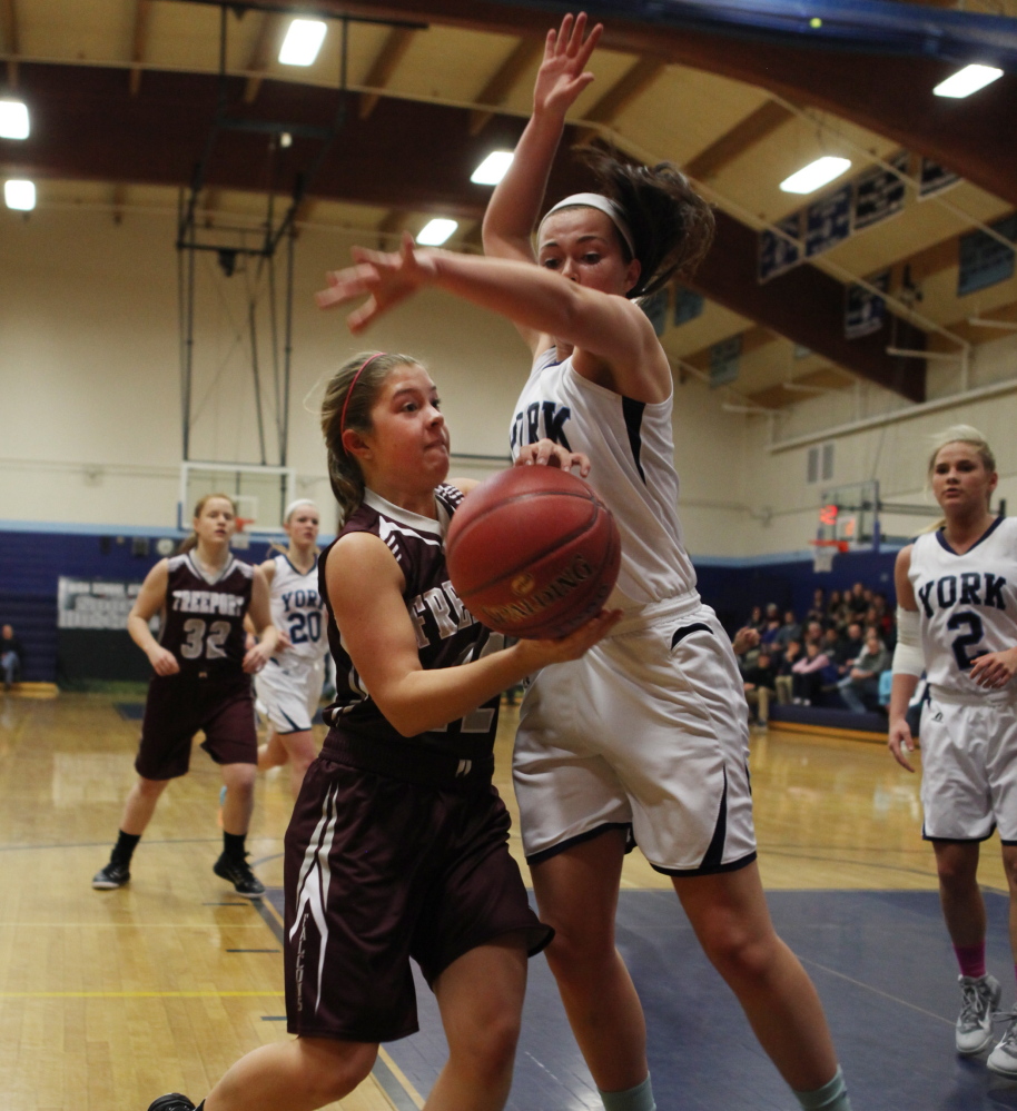 Freeport’s Bailey Karnes, left, is fouled by Erin McCafferty of York as she goes to the basket during their Western Maine Conference game Thursday night in York. York improved to 4-1 with a 67-27 victory.