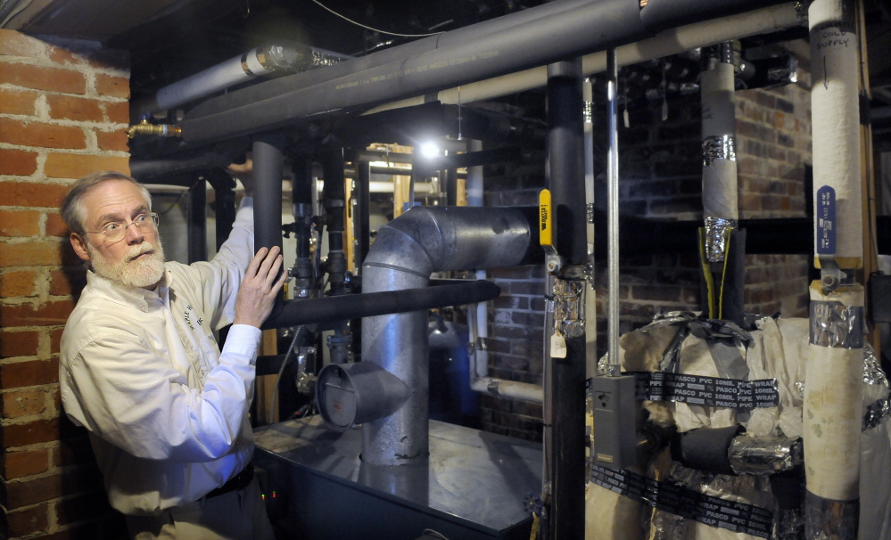 Maple Hill Farm Inn proprietor Scott Cowger shows the pipes connecting the oil and pellet heating systems Wednesday at the Hallowell bed-and-breakfast and meeting center.  Andy Molloy/Kennebec Journal