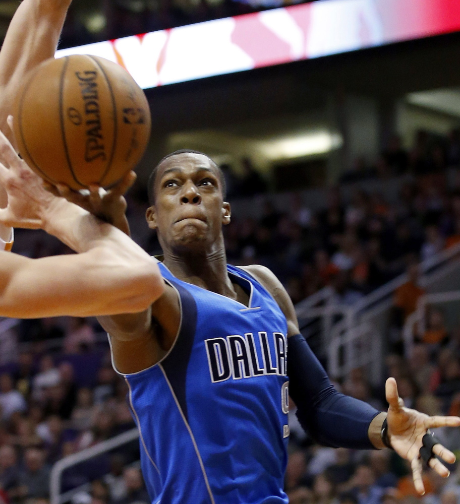 Dallas Mavericks’ Rajon Rondo tries to get off a shot as Phoenix Suns’ Alex Len and Goran Dragic defend Dec. 23 in Phoenix.