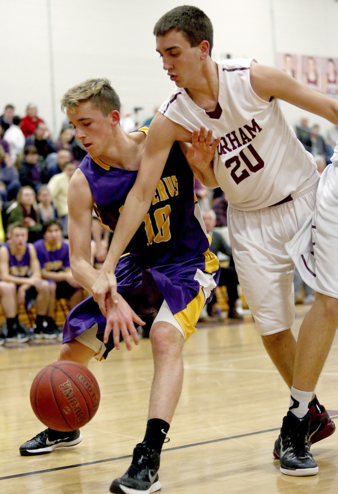 Derek Hammond of Cheverus tries to fend off Gorham's Spencer Ruda.
Gabe Souza/Staff Photographer