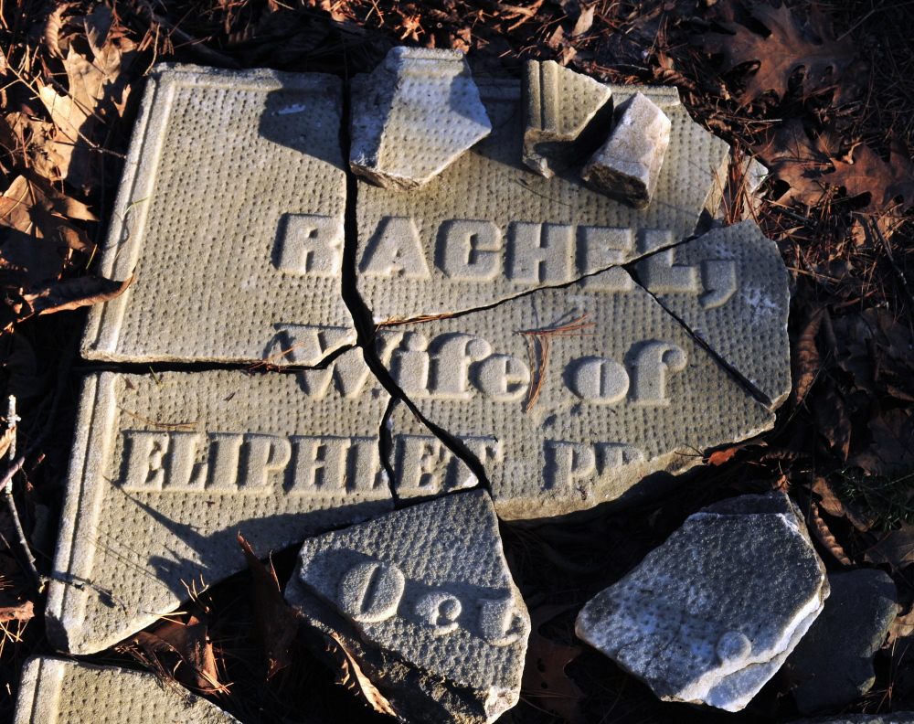 Pieces of broken tombstone sit on the ground in the Edgecomb cemetery last week in Gardiner.