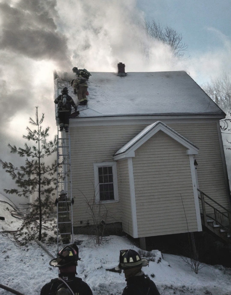 Firefighters battle a fire that destroyed a house at 4 Libby Court in Bath on Thursday morning.