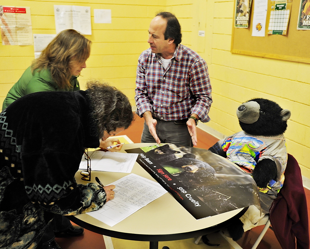 Robert Goldman, who is with the Humane Society, talks to voters in November 2013 and requests that they sign a petition to put their bear hunting question on the ballot. Voters in 2014 rejected the ballot measure that sought to make it illegal for hunters to use bait, traps or hounds to hunt bears.